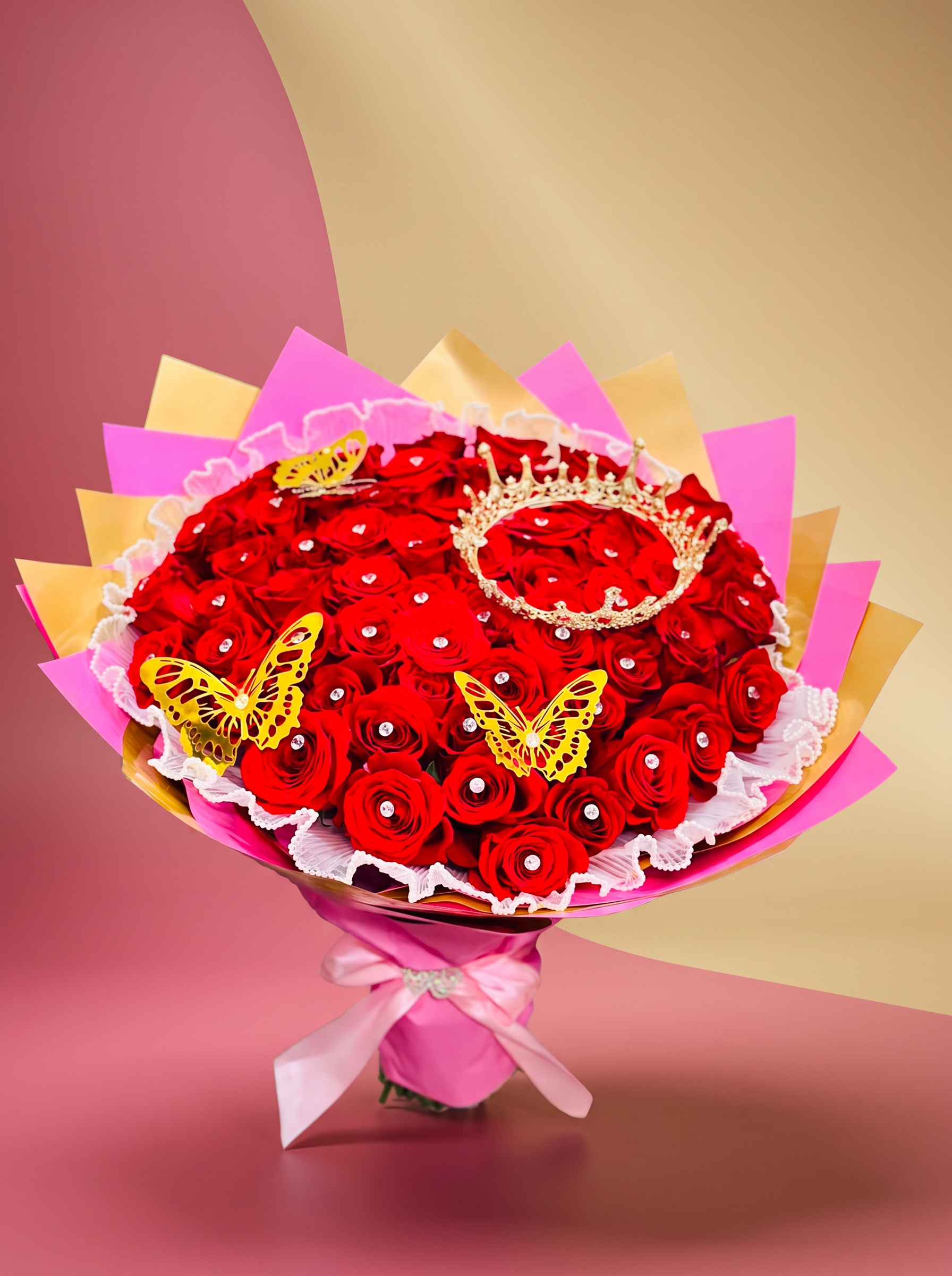Large red rose bouquet crowned with a gold tiara and butterflies